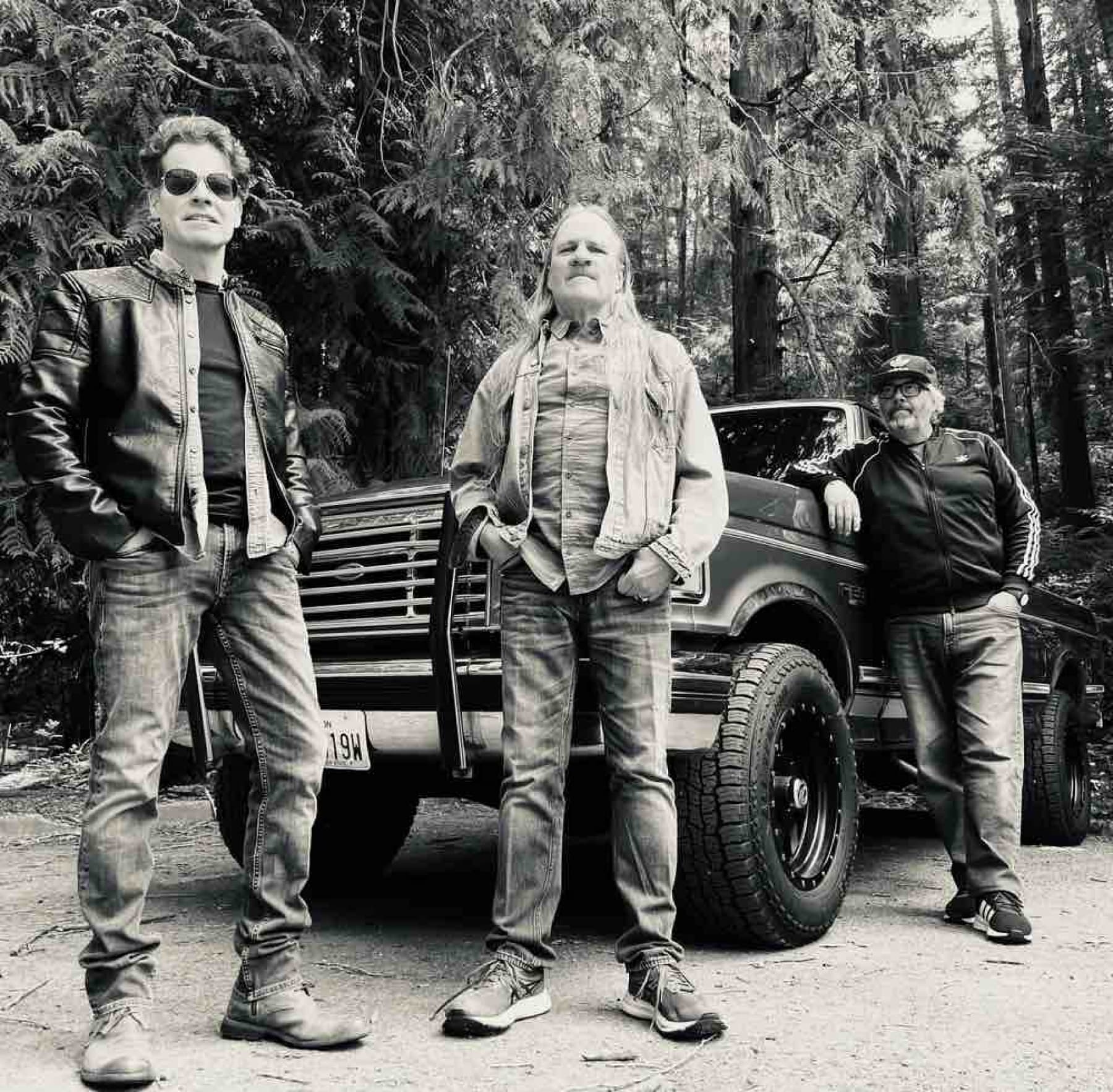 Rusty Cage Trio in front of a Ford pickup